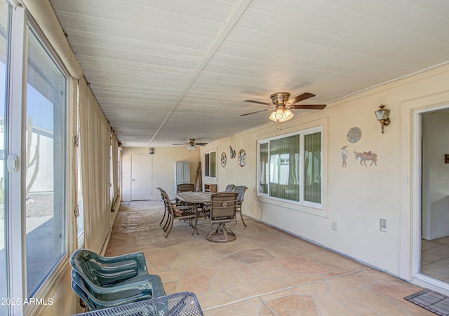 sunroom featuring ceiling fan