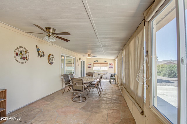 sunroom / solarium featuring ceiling fan