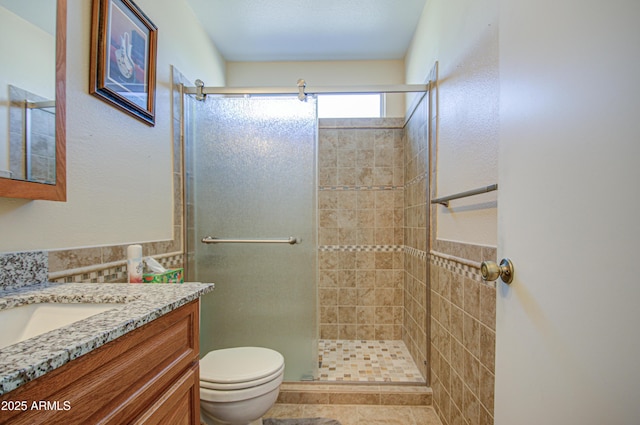 bathroom featuring vanity, toilet, and an enclosed shower