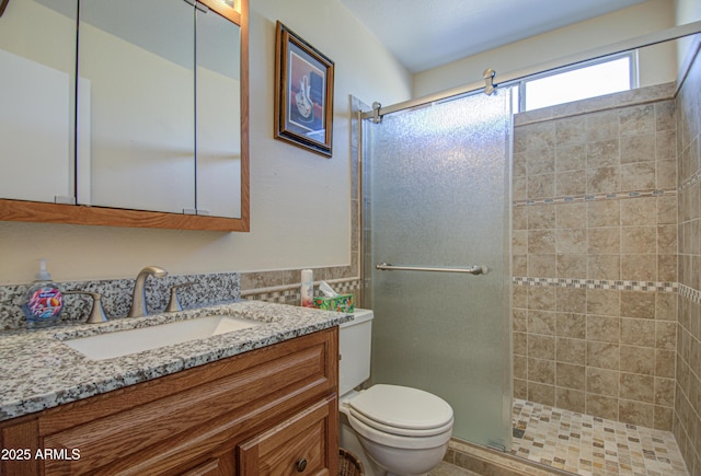 bathroom with vanity, a shower with shower door, and toilet