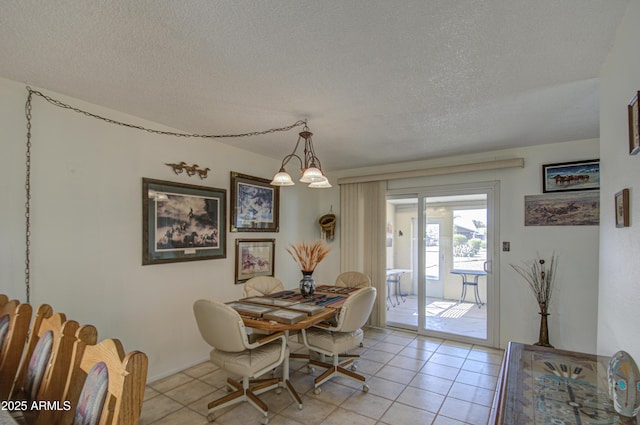 tiled dining room featuring a textured ceiling and a notable chandelier