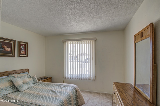 bedroom featuring light carpet and a textured ceiling