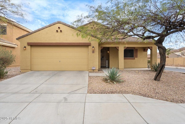 view of front of house with a garage, driveway, a tiled roof, and stucco siding