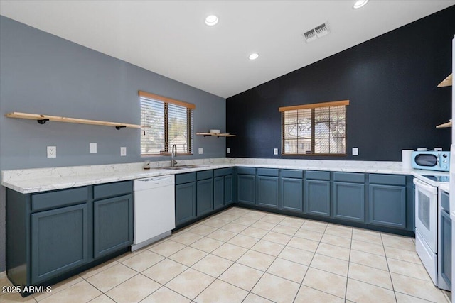 kitchen featuring white appliances, visible vents, lofted ceiling, open shelves, and a sink