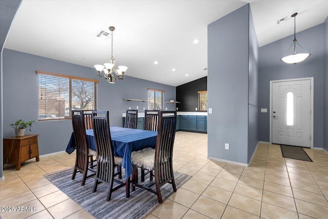 dining area with visible vents, an inviting chandelier, light tile patterned flooring, vaulted ceiling, and baseboards