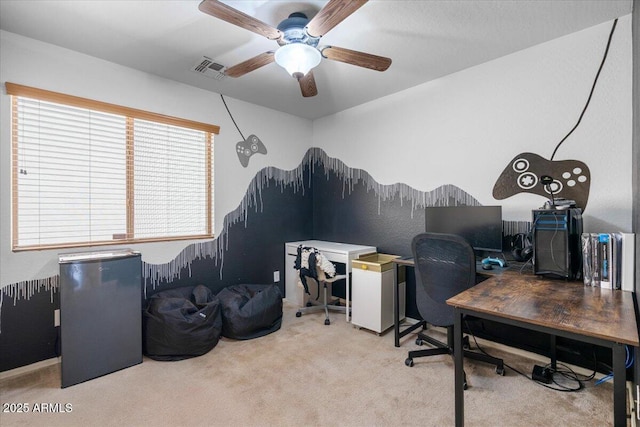 carpeted home office featuring visible vents and a ceiling fan