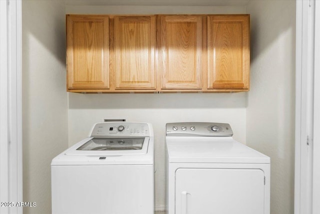 laundry area featuring cabinet space and washer and clothes dryer