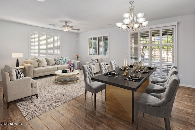 dining area with a wealth of natural light and ceiling fan with notable chandelier