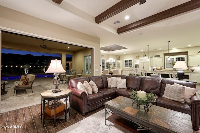 living area featuring recessed lighting, ceiling fan with notable chandelier, wood finish floors, visible vents, and beamed ceiling