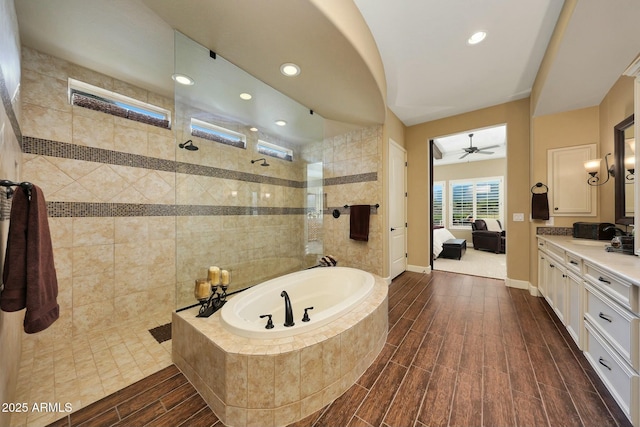 ensuite bathroom with a garden tub, ensuite bathroom, wood tiled floor, vanity, and walk in shower