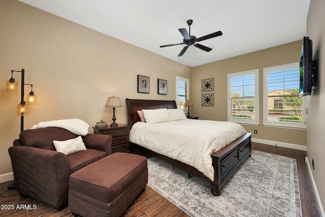 bedroom with dark wood-style floors, multiple windows, and baseboards