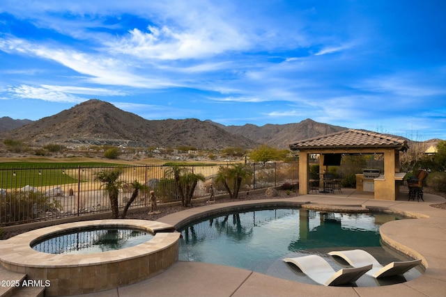 view of pool with a patio, a fenced backyard, a mountain view, a gazebo, and exterior kitchen