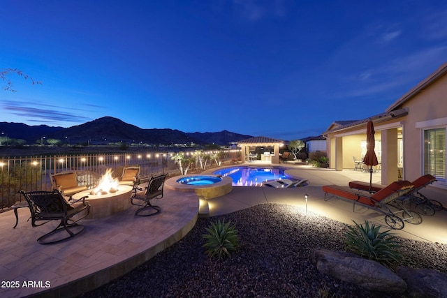 view of pool featuring a patio, a pool with connected hot tub, a gazebo, a mountain view, and a fire pit