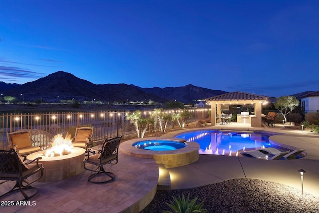 view of swimming pool featuring an outdoor fire pit, a mountain view, fence, a gazebo, and a patio area