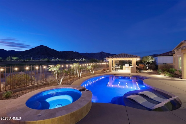 view of swimming pool with a patio area, a mountain view, a gazebo, and fence