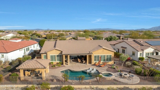 rear view of house featuring a tile roof, a patio area, a mountain view, a residential view, and a fenced backyard