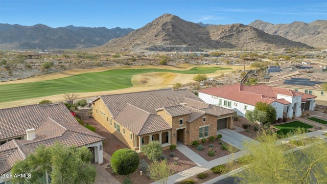 aerial view with view of golf course and a mountain view