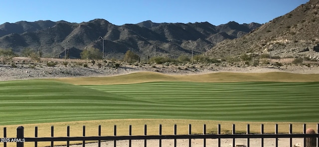 surrounding community featuring a mountain view, golf course view, and a yard