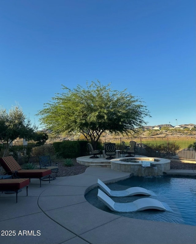 view of patio featuring a pool with connected hot tub and fence