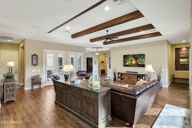 living area with dark wood finished floors and visible vents