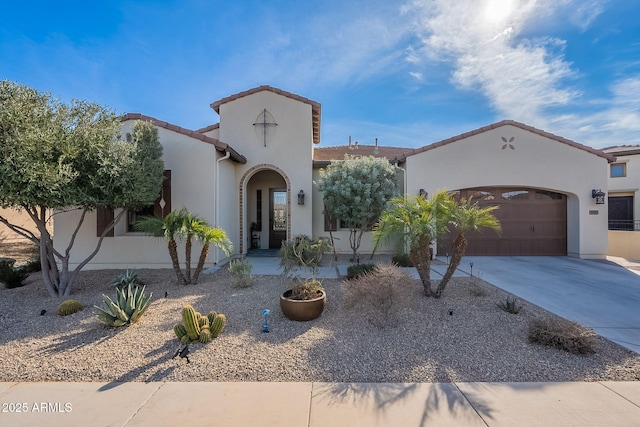 mediterranean / spanish-style house with a garage