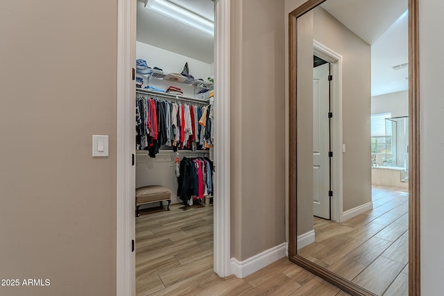 corridor with light hardwood / wood-style floors