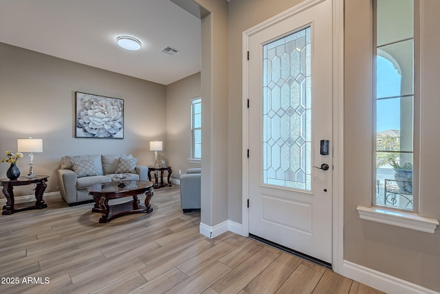 foyer entrance with light hardwood / wood-style flooring