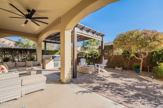 view of patio featuring an outdoor living space with a fire pit, ceiling fan, and an outdoor kitchen