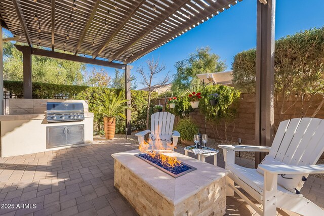 view of patio / terrace with a pergola, an outdoor kitchen, grilling area, and an outdoor fire pit