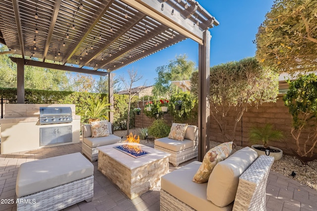 view of patio / terrace featuring exterior kitchen, grilling area, an outdoor fire pit, and a pergola