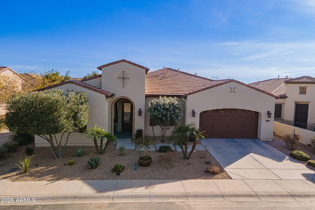 mediterranean / spanish home featuring a garage