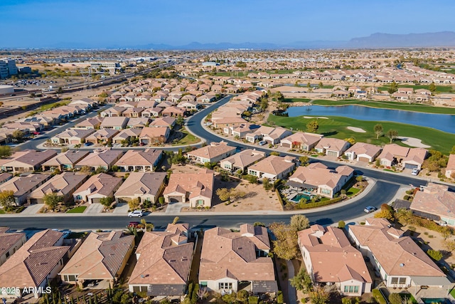 drone / aerial view with a water and mountain view