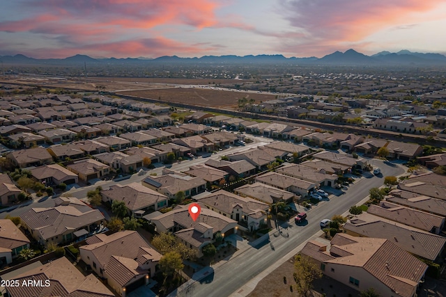 aerial view at dusk featuring a mountain view