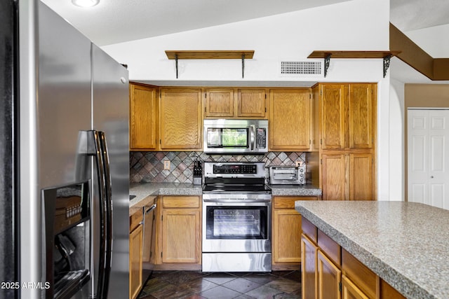 1245 W Cindy St, Chandler, AZ 85224 - kitchen with stainless steel appliances, backsplash, brown cabinetry, and light countertops