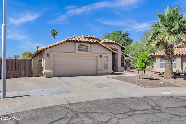 1245 W Cindy St, Chandler, AZ 85224 - mediterranean / spanish-style home featuring a tiled roof, stucco siding, a garage, and concrete driveway