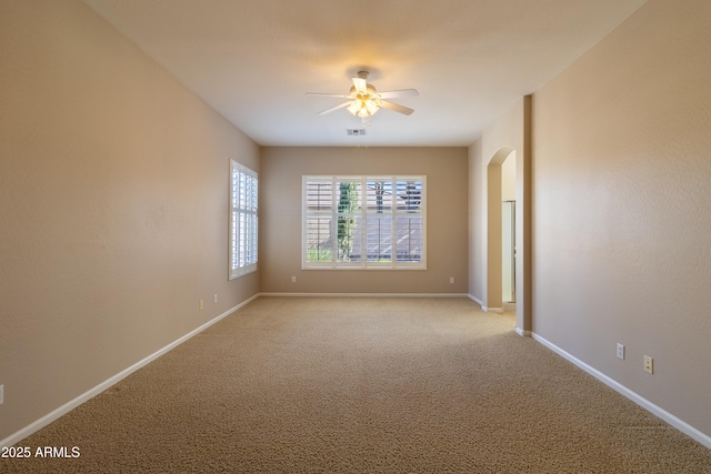 4241 E Andre Ave, Gilbert, AZ 85298 - spare room with a ceiling fan, arched walkways, and light carpet