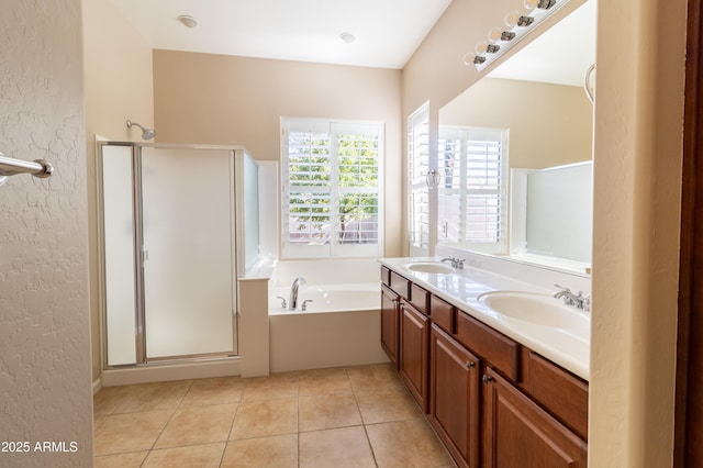 4241 E Andre Ave, Gilbert, AZ 85298 - bathroom featuring a textured wall, a bath, a shower stall, double vanity, and tile patterned floors