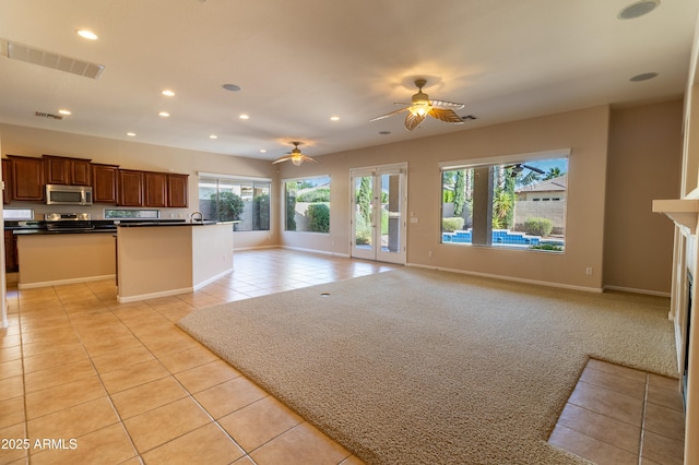 4241 E Andre Ave, Gilbert, AZ 85298 - kitchen featuring stainless steel microwave, open floor plan, light tile patterned floors, and recessed lighting
