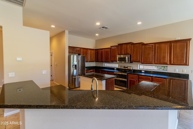 4241 E Andre Ave, Gilbert, AZ 85298 - kitchen with stainless steel appliances, a kitchen island, dark stone counters, recessed lighting, and a peninsula