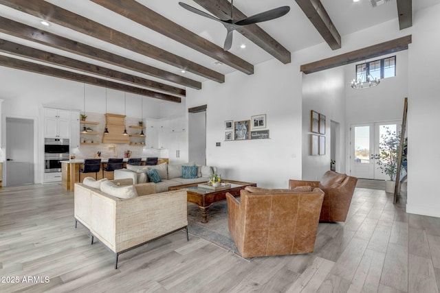 35150 N Bell Rd, Queen Creek, AZ 85144 - living area with light wood finished floors, beam ceiling, ceiling fan with notable chandelier, and a towering ceiling