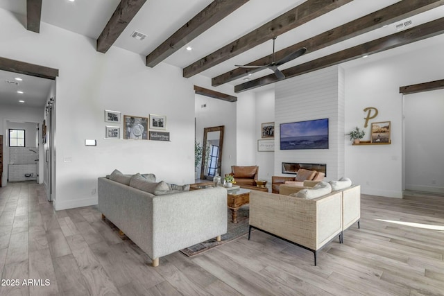 35150 N Bell Rd, Queen Creek, AZ 85144 - living area featuring light wood finished floors, visible vents, a large fireplace, and baseboards