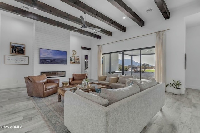 35150 N Bell Rd, Queen Creek, AZ 85144 - living area featuring baseboards, visible vents, light wood-style flooring, a fireplace, and beamed ceiling