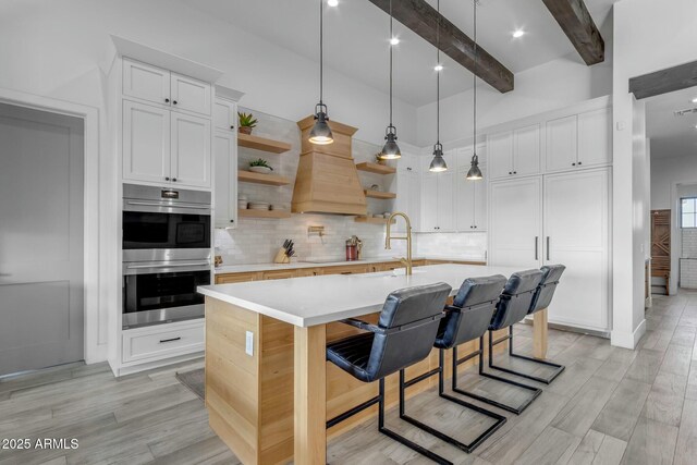 35150 N Bell Rd, Queen Creek, AZ 85144 - kitchen featuring backsplash, double oven, light countertops, beam ceiling, and open shelves