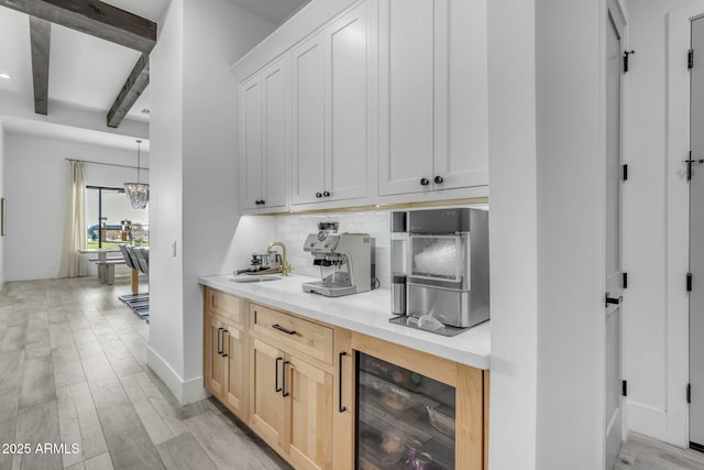 35150 N Bell Rd, Queen Creek, AZ 85144 - bar with beamed ceiling, beverage cooler, light wood-style flooring, decorative backsplash, and baseboards