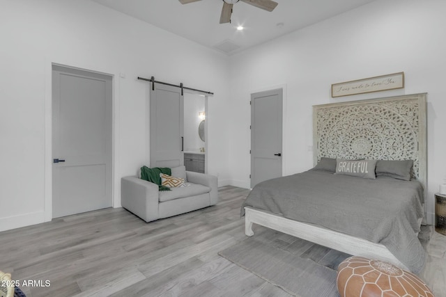 35150 N Bell Rd, Queen Creek, AZ 85144 - bedroom featuring baseboards, a ceiling fan, a barn door, and wood finished floors