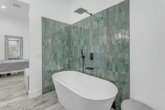 35150 N Bell Rd, Queen Creek, AZ 85144 - ensuite bathroom with connected bathroom, a walk in shower, wood finished floors, and a freestanding tub