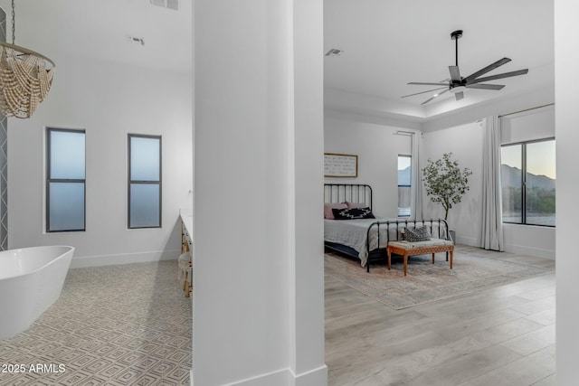 35150 N Bell Rd, Queen Creek, AZ 85144 - interior space featuring wood finished floors, baseboards, ceiling fan, a freestanding bath, and ensuite bathroom