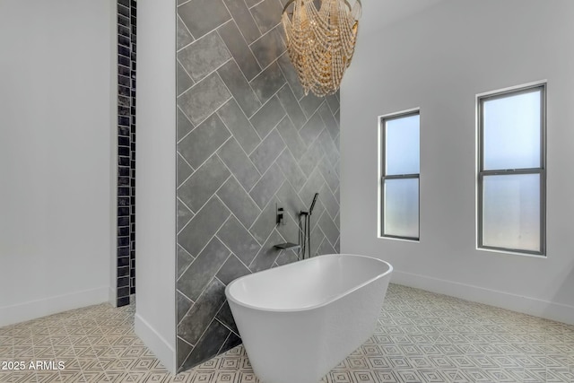 35150 N Bell Rd, Queen Creek, AZ 85144 - bathroom featuring baseboards, a freestanding bath, tile walls, a notable chandelier, and tile patterned floors