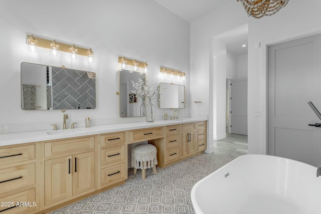 35150 N Bell Rd, Queen Creek, AZ 85144 - bathroom featuring double vanity, a freestanding tub, and a sink