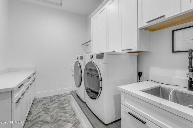 35150 N Bell Rd, Queen Creek, AZ 85144 - washroom featuring baseboards, washing machine and clothes dryer, cabinet space, brick floor, and a sink